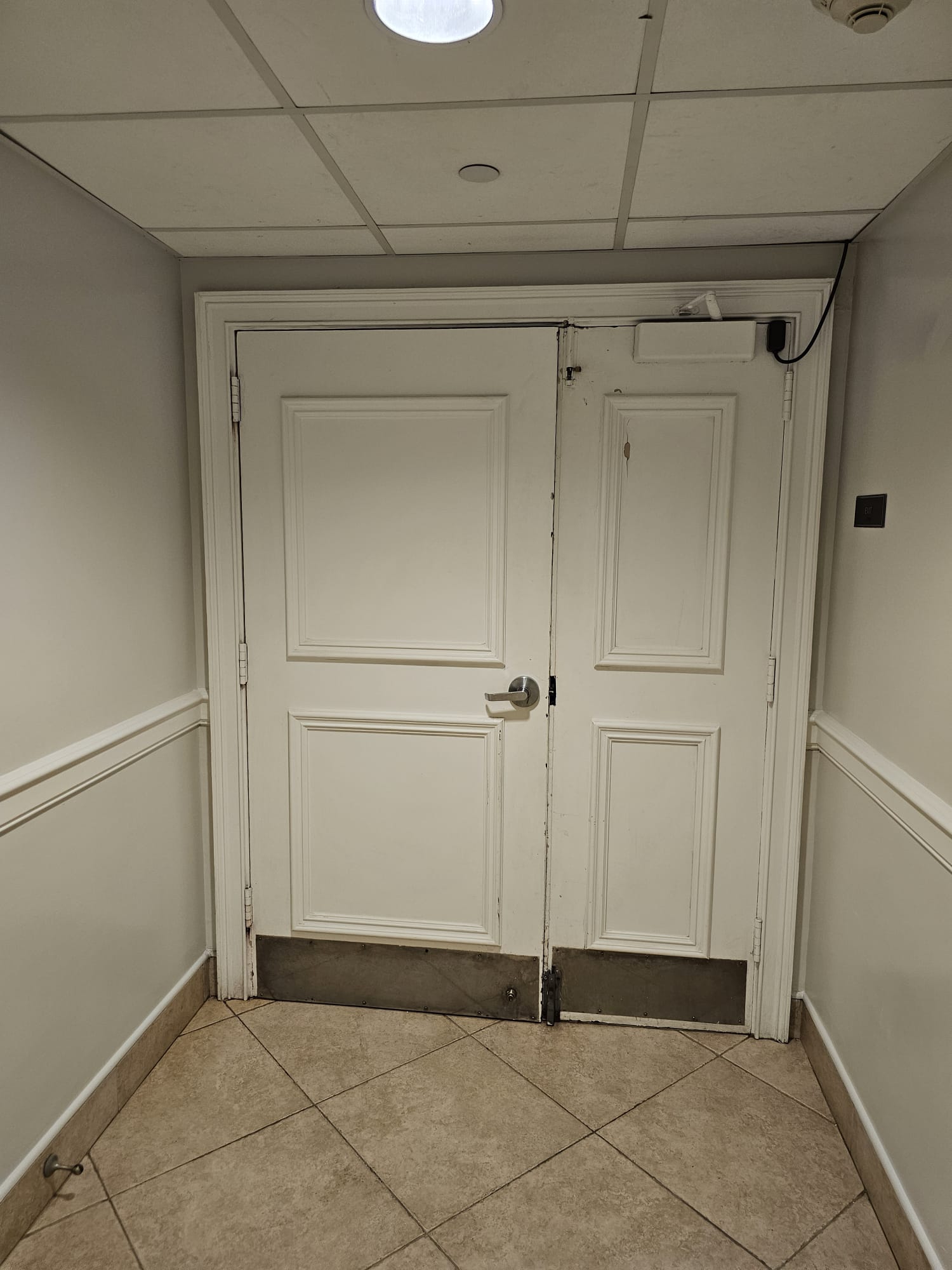 Building-side view of the commercial double-door assembly