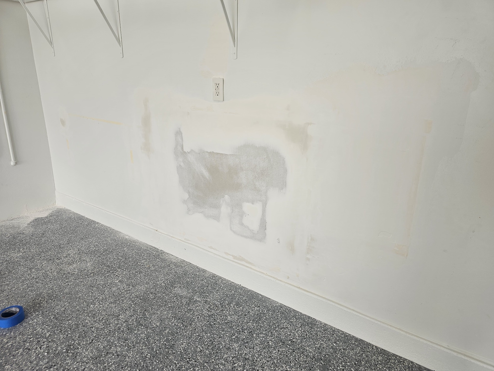 Garage-side drywall repair after patching and sanding