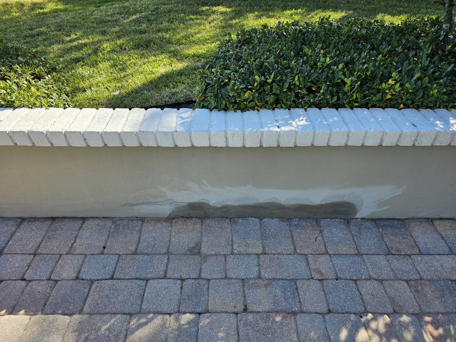 Blended repair area along the poolside stucco wall