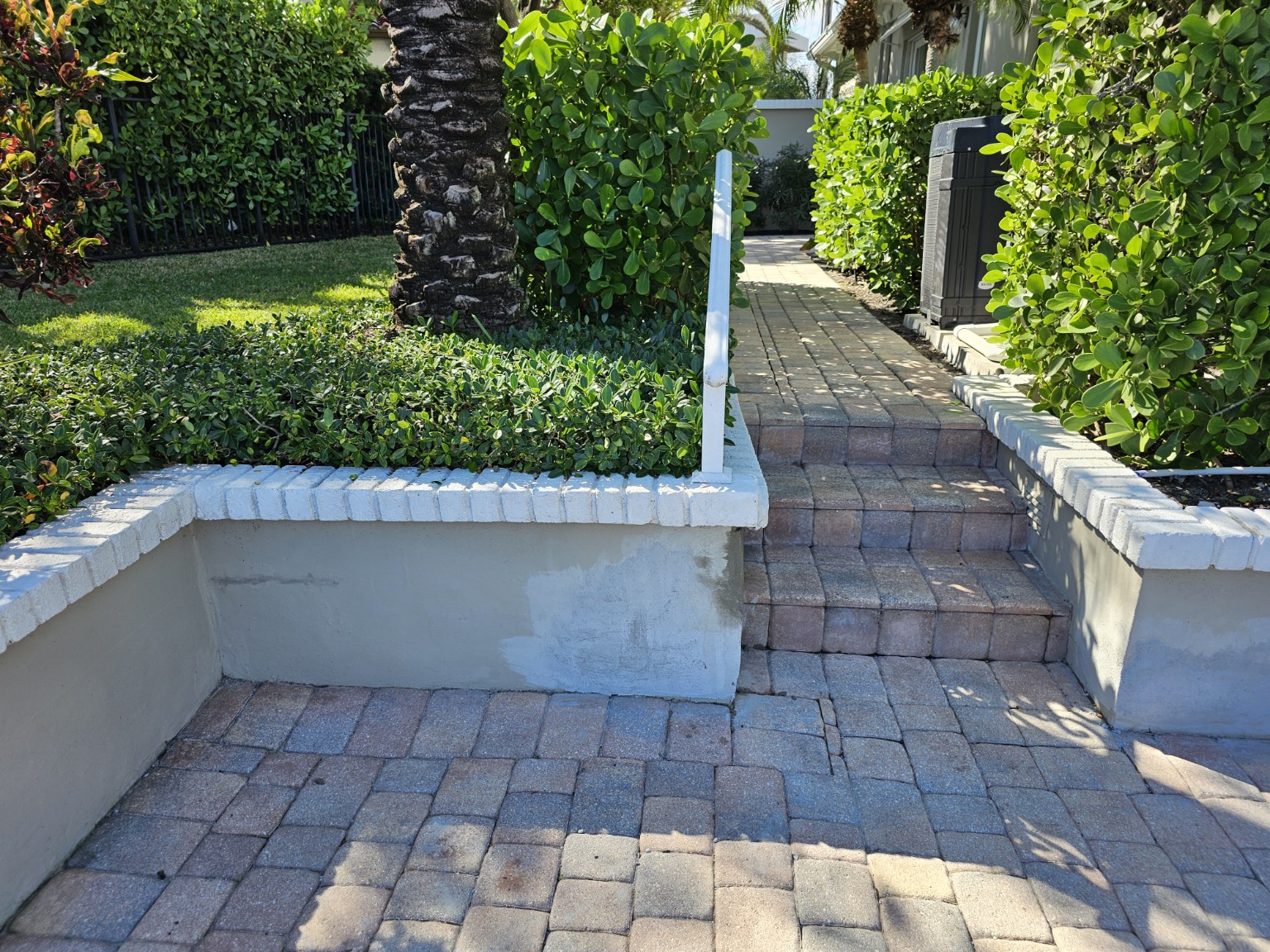 Repaired garden walls surrounding a landscaped walkway