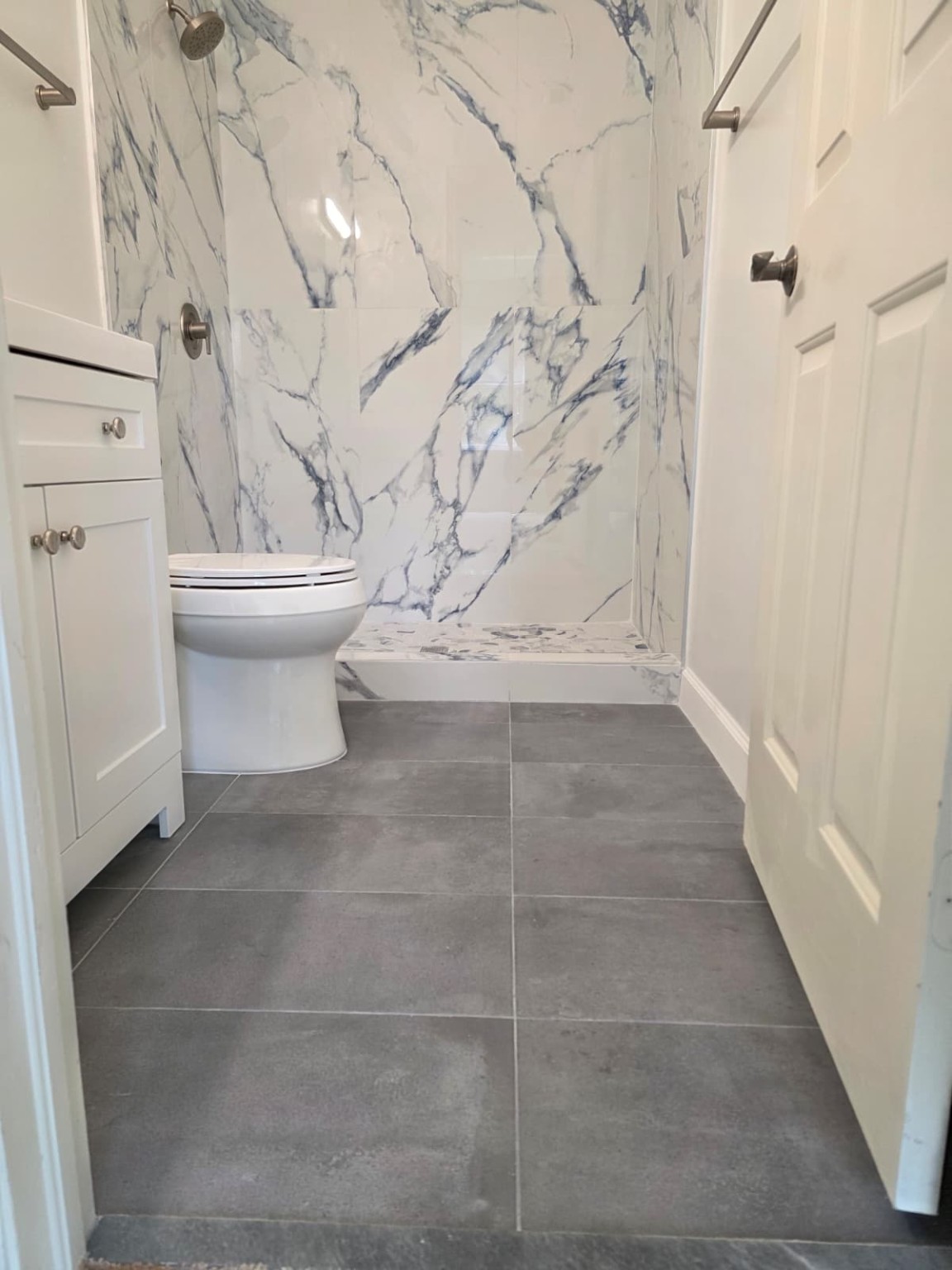 Completed gray floor tile and rebuilt walk-in shower